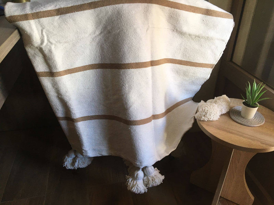 MOROCCO: Handmade Moroccan white pom-pom blanket with camel stripes