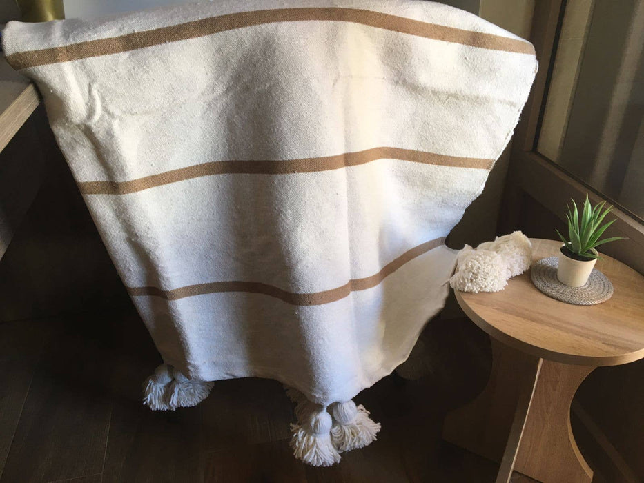MOROCCO: Handmade Moroccan white pom-pom blanket with camel stripes