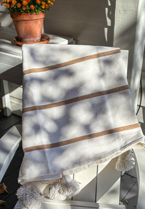 MOROCCO: Handmade Moroccan white pom-pom blanket with camel stripes