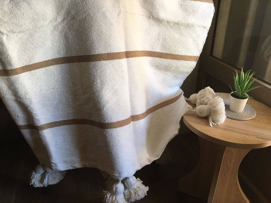 MOROCCO: Handmade Moroccan white pom-pom blanket with camel stripes
